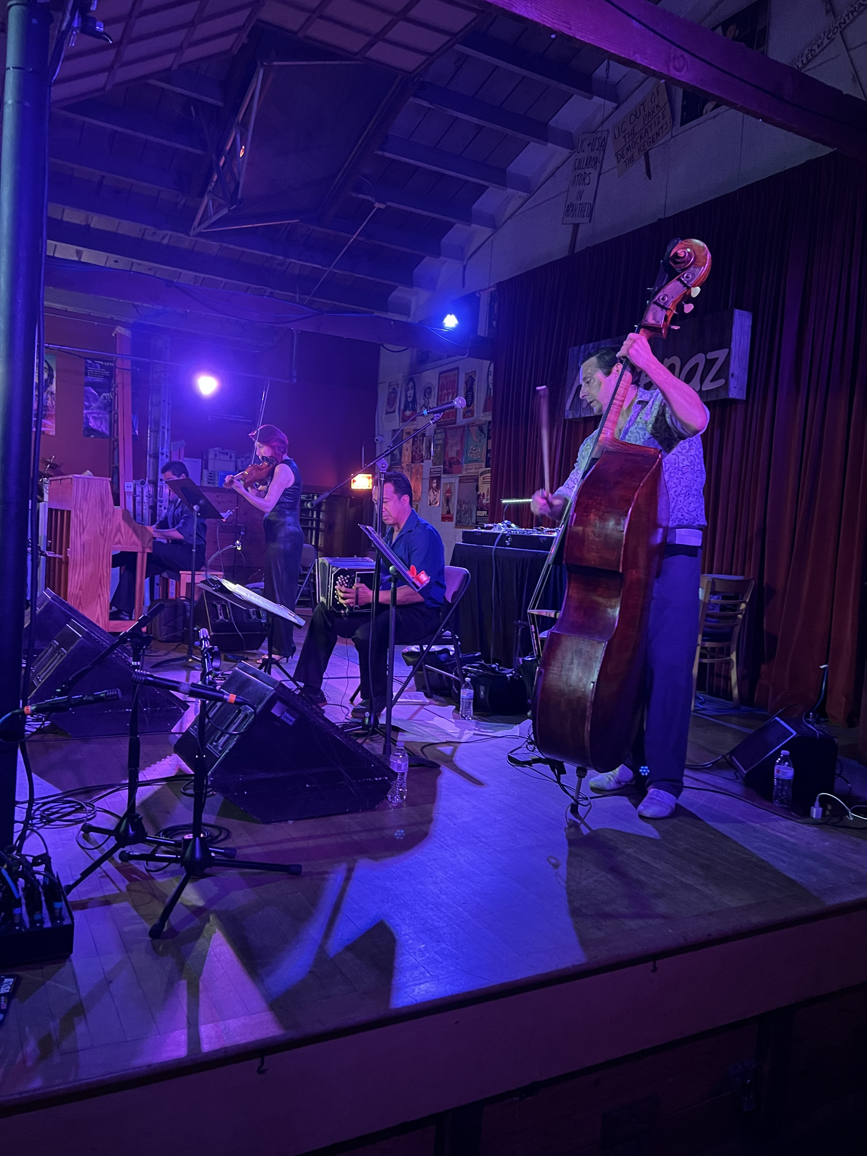 Side view of the live tango ensemble performing at Ashkenaz with the double bass in the foreground.