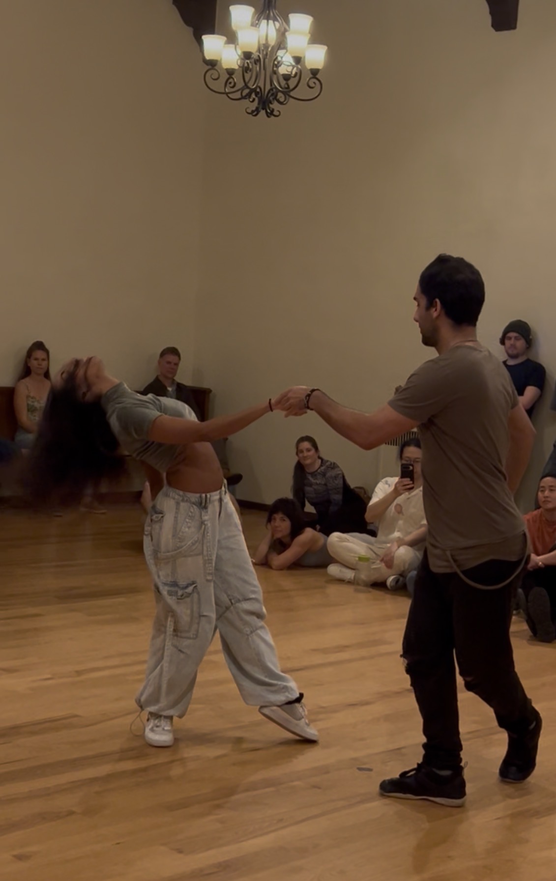 Brazilian Zouk demonstration during OmniZouk practica with dancers and attendees watching.